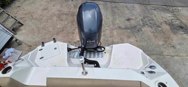 Slide: The Image of 2019 NauticStar 223DC Sport Deck boat with 150 HP outboard motor, viewed from above. - 12