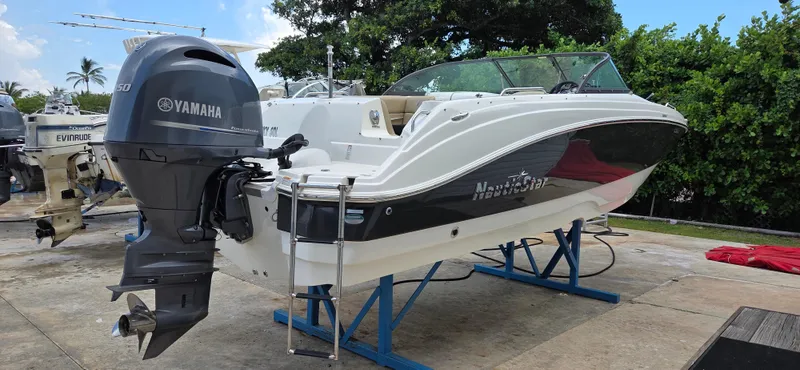 Slide: The Image of 2019 NauticStar 223DC Sport Deck boat with Yamaha engine on display stand. - 6