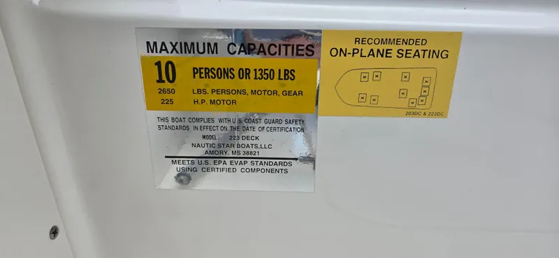 Slide: The Image of 2019 NauticStar 223DC Sport Deck capacity label, 10 persons or 1350 lbs, safety compliance. - 8