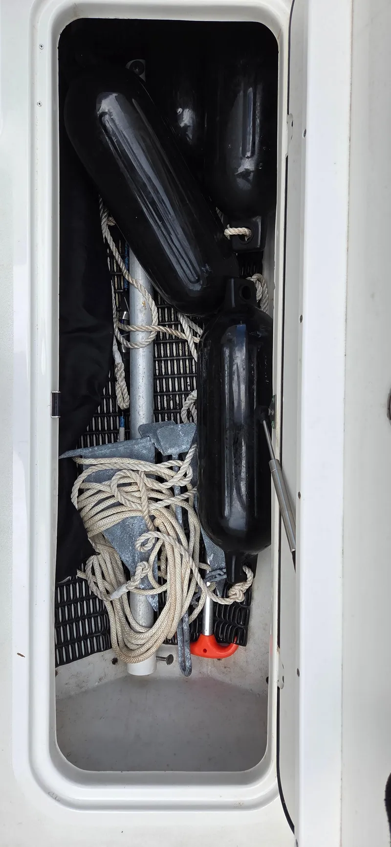 Slide: The Image of 2019 NauticStar 223DC Sport Deck storage with anchor, ropes, and fenders. - 9