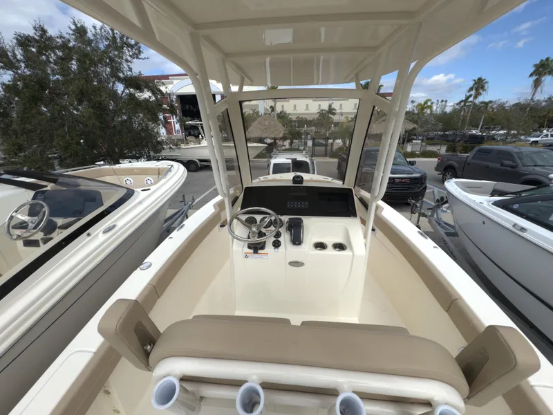 Slide: The Image of 2025 Scout 215 XSF boat interior with steering console and seating. - 10