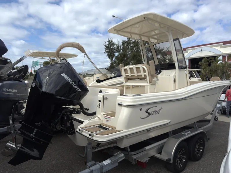 Slide: The Image of 2025 Scout 215 XSF boat on trailer with Mercury outboard motor. - 2