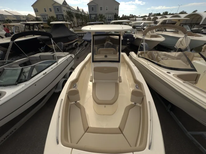 Slide: The Image of 2025 Scout 215 XSF boat in marina, surrounded by other boats. - 4