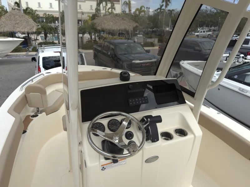 Slide: The Image of 2025 Scout 215 XSF boat dashboard with steering wheel and controls. - 8