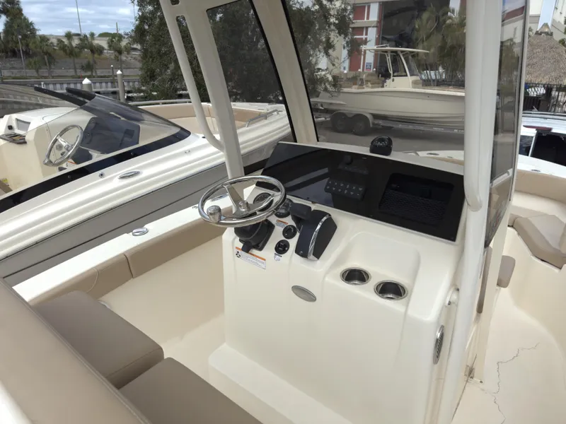 Slide: The Image of 2025 Scout 215 XSF boat interior with steering console and seating. - 9