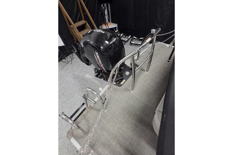 Slide: The Image of 2026 Barletta ARIA 22UC boat with Mercury outboard motor, displayed indoors. - 11