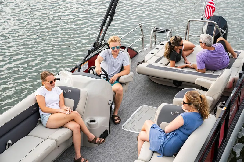 Slide: The Image of 2026 Barletta ARIA 22UC pontoon boat in showroom, featuring Mercury outboard motor. - 2