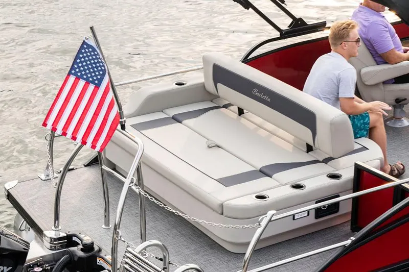 Slide: The Image of Luxurious seating in the 2026 Barletta ARIA 22UC pontoon boat, featuring cup holders and speakers. - 4