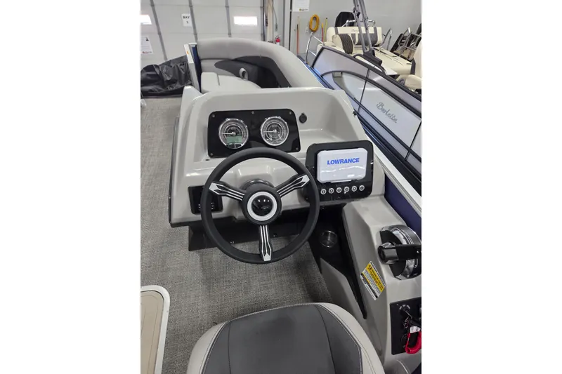 Slide: The Image of Cockpit of 2026 Barletta ARIA 22UC boat with steering wheel and Lowrance display. - 7