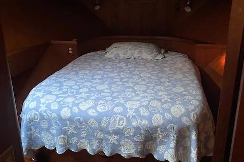 Slide: The Image of Cozy bedroom in 1984 Nova Trawler Heritage boat with seashell-patterned bedding. - 10