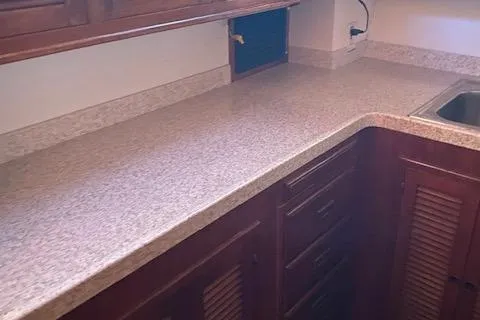 Slide: The Image of 1984 Nova Trawler Heritage kitchen with wooden cabinets and granite countertops. - 13