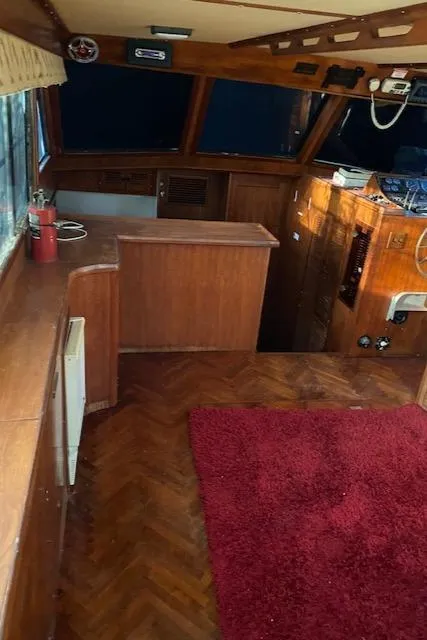 Slide: The Image of 1984 Nova Trawler Heritage interior with wood paneling and red carpet. - 17