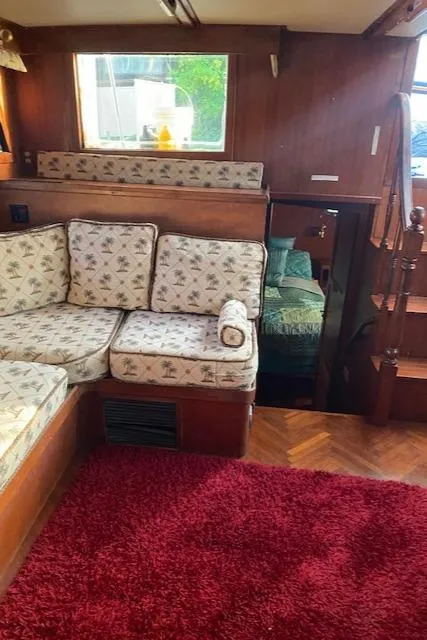 Slide: The Image of Interior of 1984 Nova Trawler Heritage with floral upholstery and red carpet. - 19