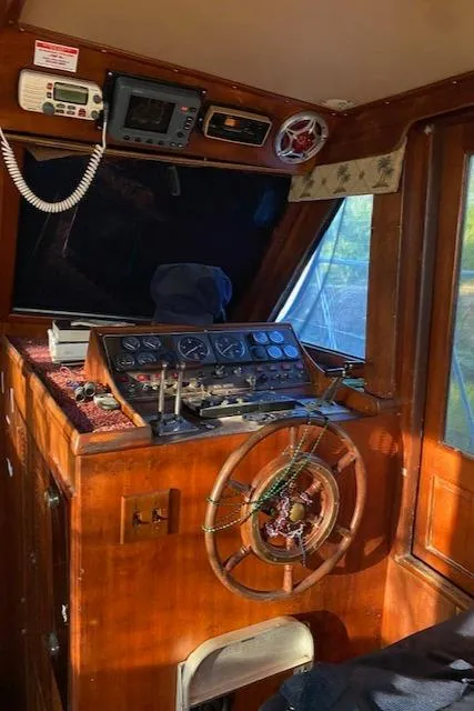 Slide: The Image of 1984 Nova Trawler Heritage boat helm with wooden steering wheel and control panel. - 20