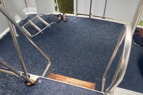 Slide: The Image of Interior of 1984 Nova Trawler Heritage with blue carpet and metal railings. - 7