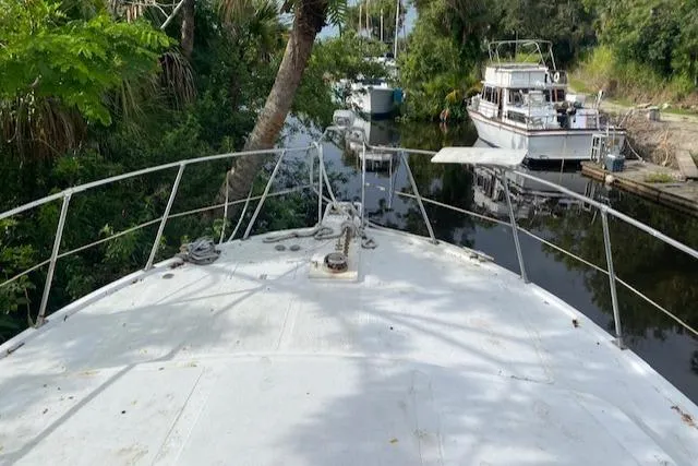 Slide: The Image of Bow view of 1984 Nova Trawler Heritage in a lush, narrow waterway. - 9