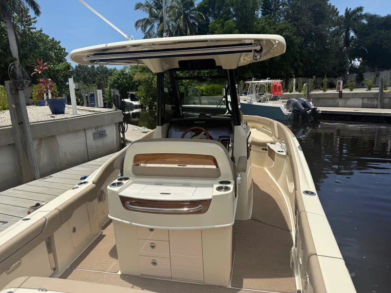 Slide: The Image of 2025 Chris-Craft Catalina 28 boat docked, showcasing sleek design and spacious deck. - 12