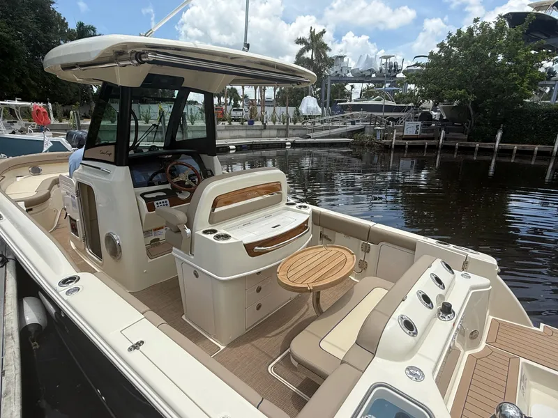 Slide: The Image of 2025 Chris-Craft Catalina 28 boat with elegant interior, docked by a serene waterfront. - 14