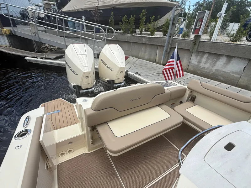 Slide: The Image of 2025 Chris-Craft Catalina 28 boat with twin Mercury engines docked by a pier. - 18