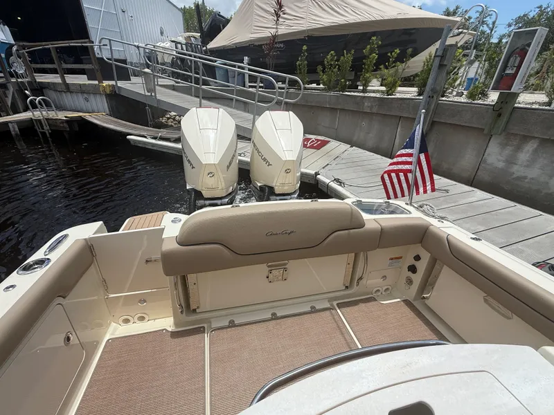 Slide: The Image of 2025 Chris-Craft Catalina 28 boat with twin Mercury engines docked by a marina. - 21