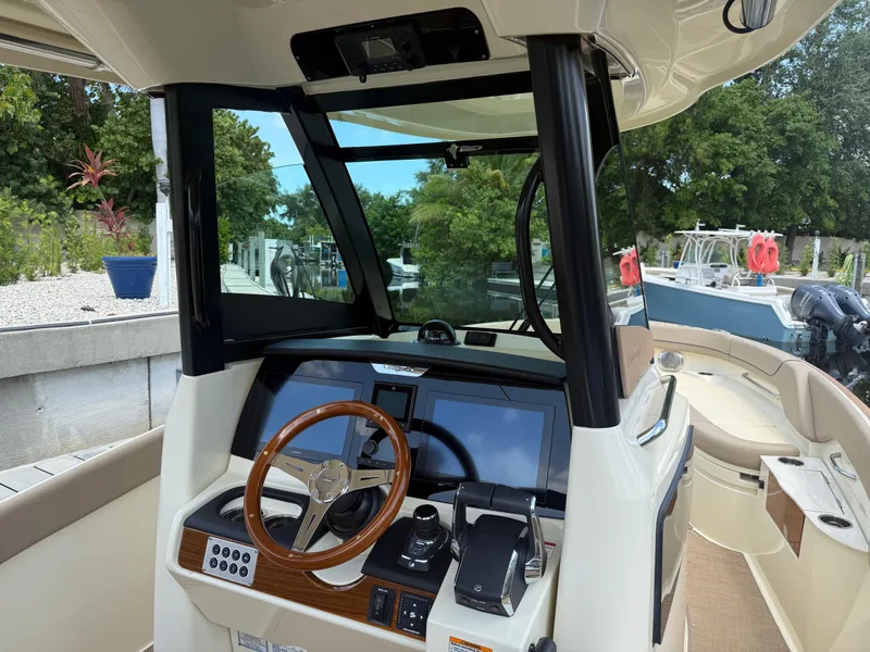 Slide: The Image of 2025 Chris-Craft Catalina 28 helm with modern controls and wooden steering wheel. - 22