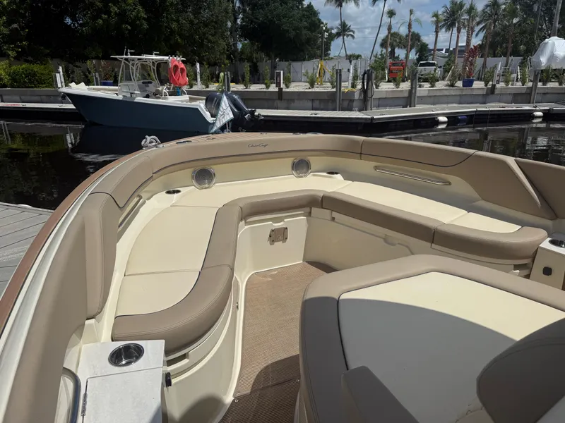 Slide: The Image of 2025 Chris-Craft Catalina 28 boat interior with beige seating at a marina. - 29