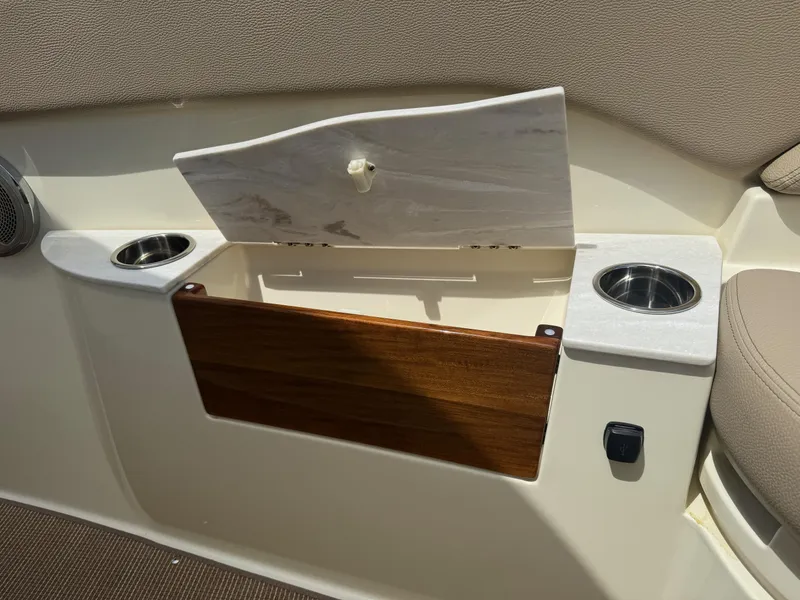 Slide: The Image of Interior of 2025 Chris-Craft Catalina 28 with storage compartment and cup holders. - 35