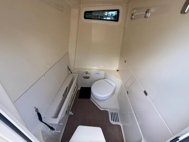 Slide: The Image of 2025 Chris-Craft Catalina 28 boat interior bathroom with toilet and window. - 36