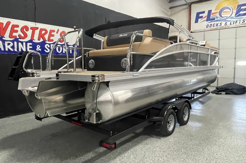 Slide: The Image of 2026 Barletta Cabrio 24UE pontoon boat on trailer in showroom. - 2