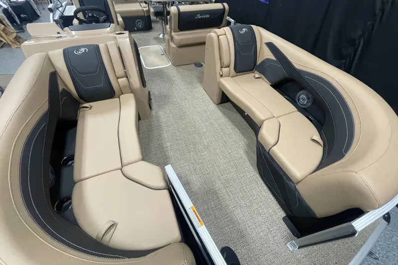 Slide: The Image of 2026 Barletta Cabrio 24UE pontoon boat interior with tan and black seating. - 4