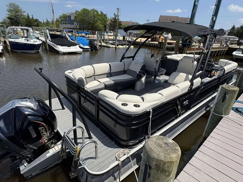 The Image of 2023 Veranda V25RCT pontoon boat docked at marina with Yamaha outboard motor. - 0