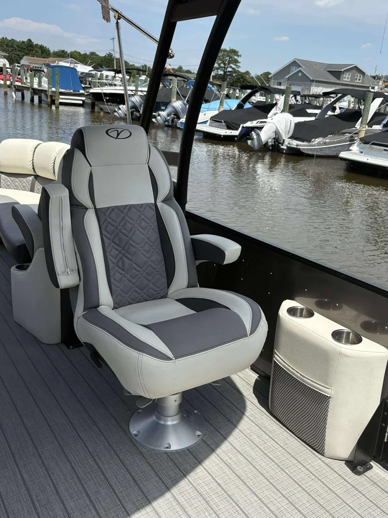 Slide: The Image of Luxurious seating on 2023 Veranda V25RCT boat, docked at marina with other vessels. - 10