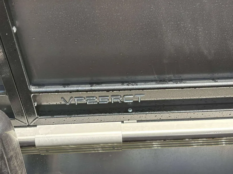 Slide: The Image of 2023 Veranda V25RCT boat model emblem with sleek metallic finish. - 11