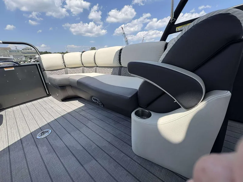 Slide: The Image of 2023 Veranda V25RCT boat interior with luxurious seating and cup holder under a blue sky. - 15