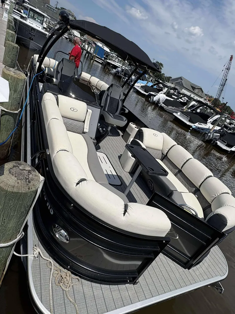 Slide: The Image of 2023 Veranda V25RCT pontoon boat docked, featuring spacious seating and sleek design. - 4