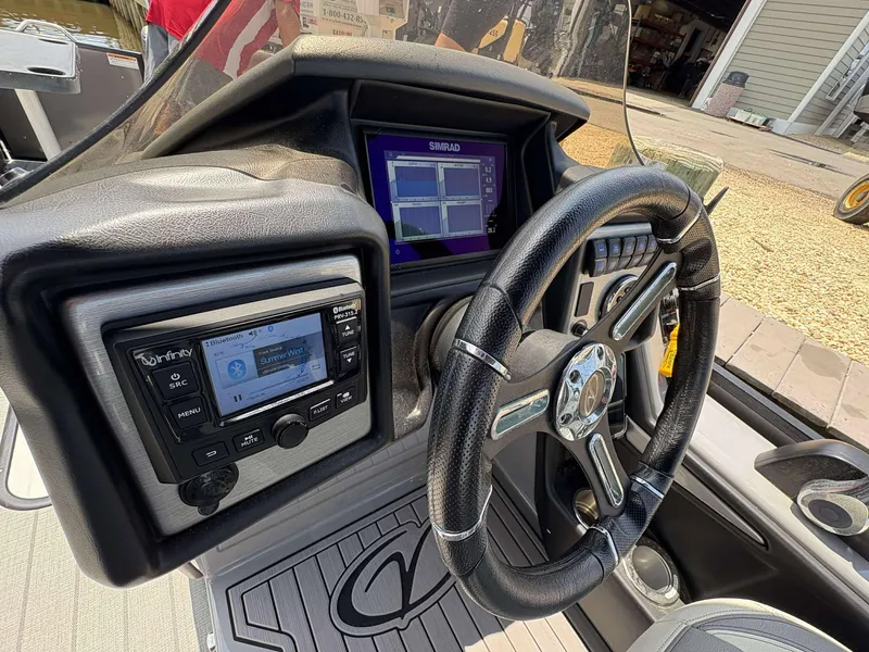 Slide: The Image of 2023 Veranda V25RCT boat dashboard with steering wheel and control panel. - 8