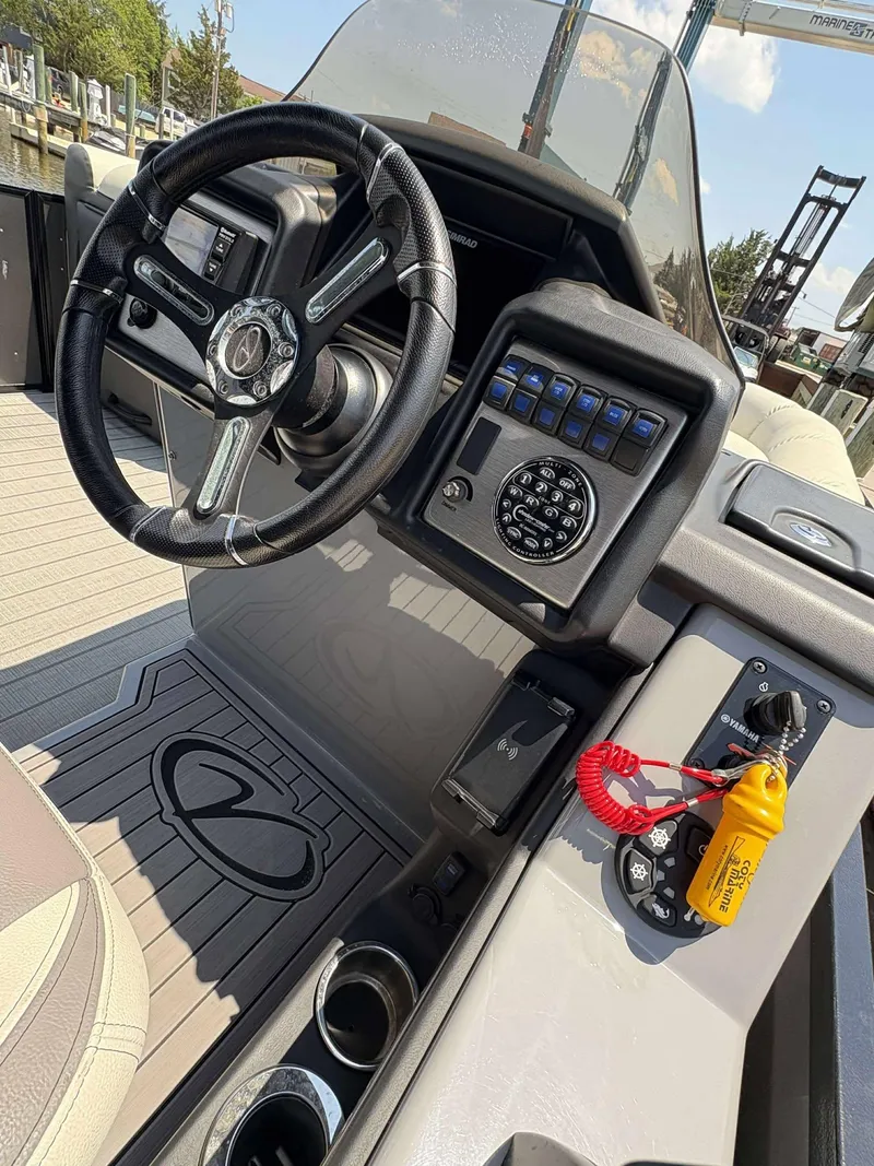 Slide: The Image of 2023 Veranda V25RCT boat dashboard with steering wheel and control panel. - 9