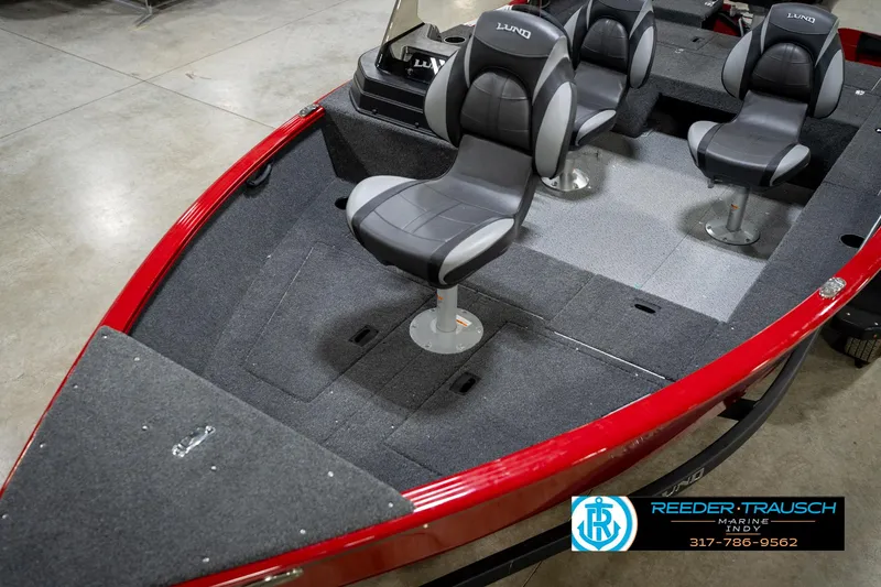 Slide: The Image of 2026 Lund 1650 Rebel XL SS boat interior with gray seating and red trim. - 10