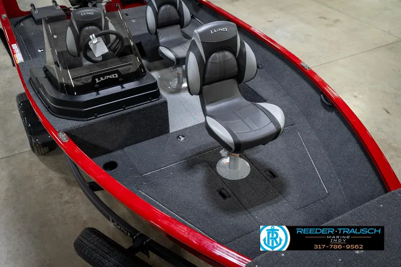 Slide: The Image of 2026 Lund 1650 Rebel XL SS boat interior with gray seating and red trim. - 11