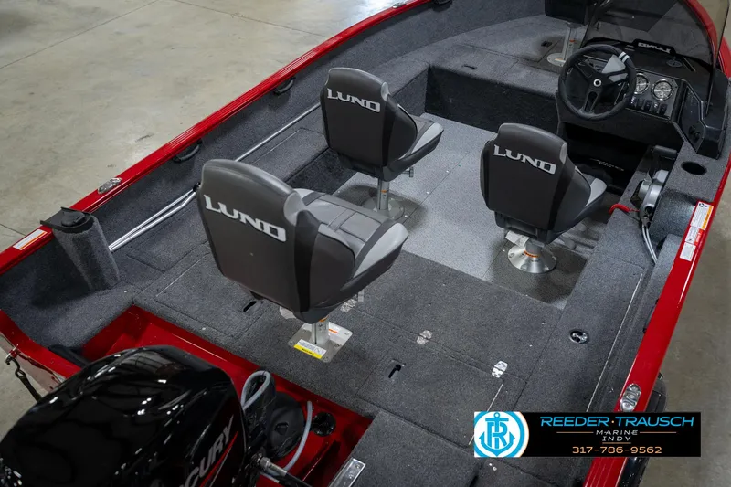 Slide: The Image of 2026 Lund 1650 Rebel XL SS boat interior with three seats and steering console. - 12