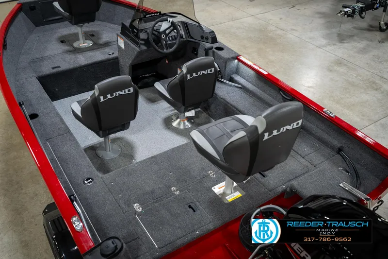 Slide: The Image of 2026 Lund 1650 Rebel XL SS boat interior with gray seating and red accents. - 13
