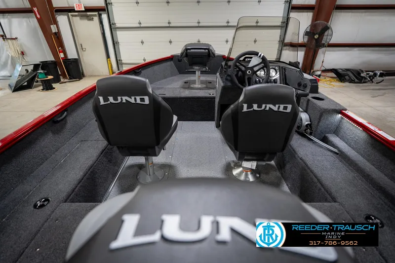Slide: The Image of 2026 Lund 1650 Rebel XL SS boat interior with dual seats and steering console. - 14