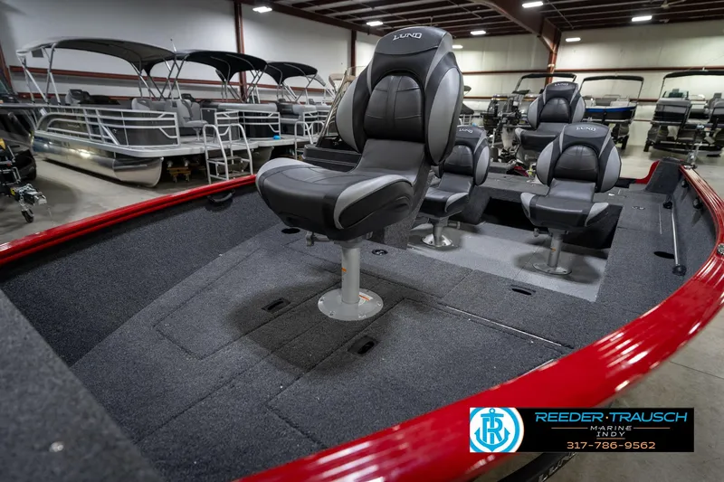 Slide: The Image of 2026 Lund 1650 Rebel XL SS boat interior with seating, displayed in a showroom. - 20