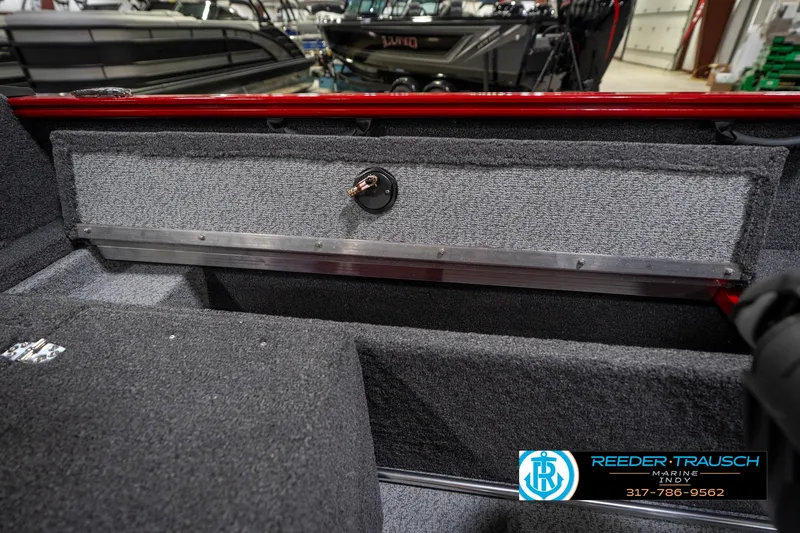 Slide: The Image of 2026 Lund 1650 Rebel XL SS boat interior with carpeted storage compartment. - 25