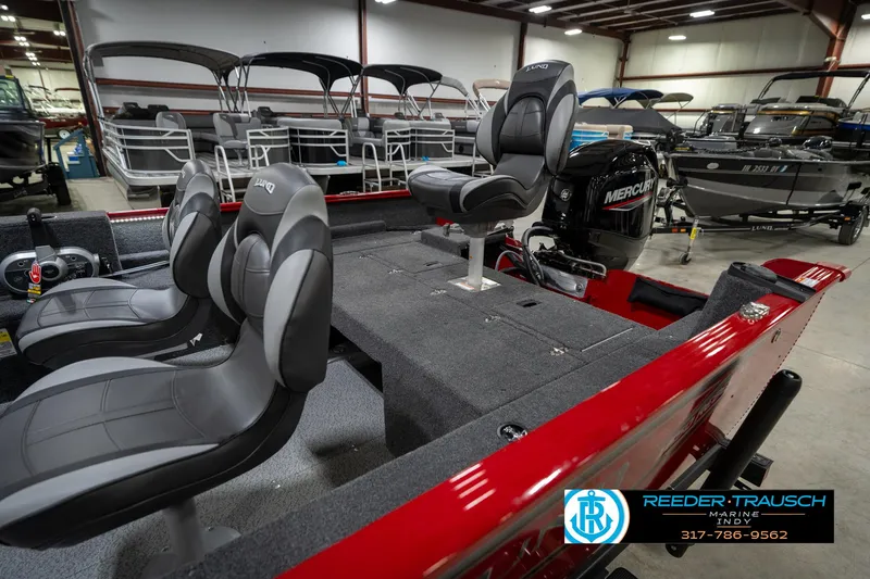 Slide: The Image of 2026 Lund 1650 Rebel XL SS boat interior with Mercury engine in showroom. - 26