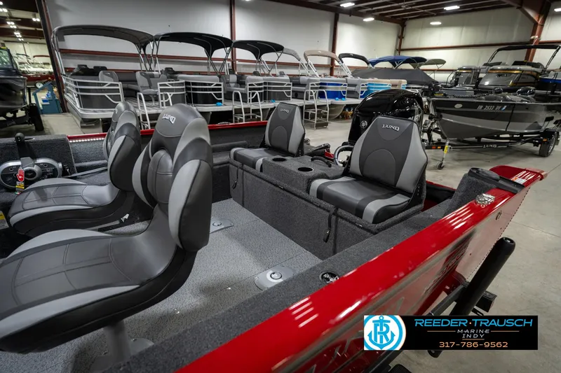 Slide: The Image of 2026 Lund 1650 Rebel XL SS boat interior with gray seats in showroom. - 30