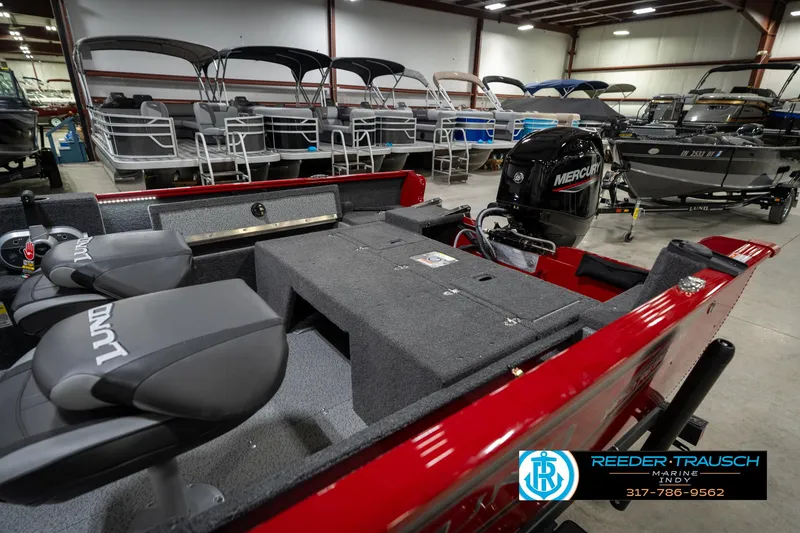 Slide: The Image of 2026 Lund 1650 Rebel XL SS boat interior with Mercury engine in showroom. - 31