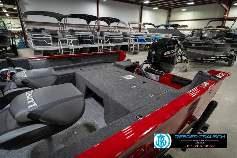 Slide: The Image of 2026 Lund 1650 Rebel XL SS boat interior with Mercury engine in showroom. - 32