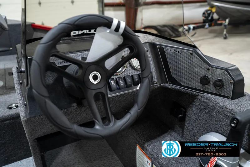 Slide: The Image of 2026 Lund 1650 Rebel XL SS boat dashboard with steering wheel and control panel. - 34