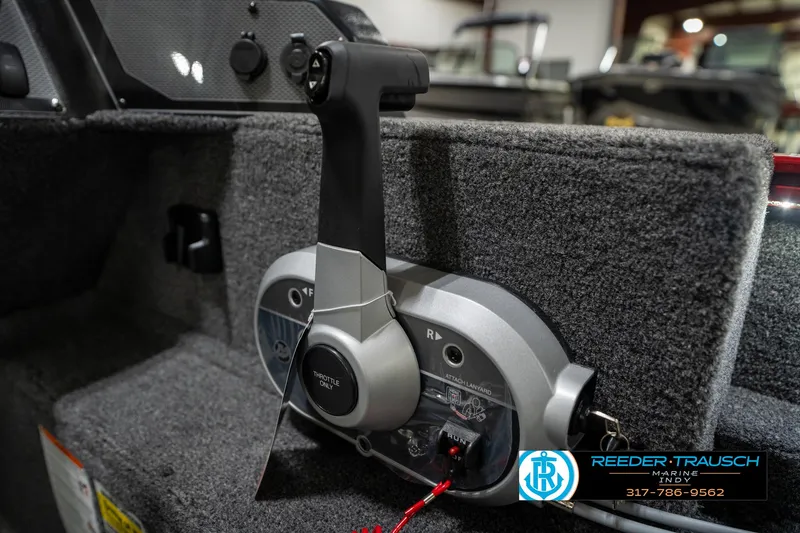 Slide: The Image of 2026 Lund 1650 Rebel XL SS throttle control in a carpeted boat interior. - 38